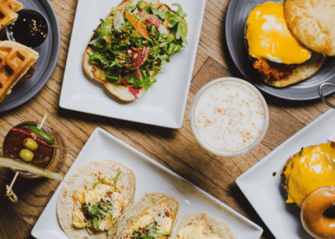 Rustic bar interior with wooden stools and brick wall